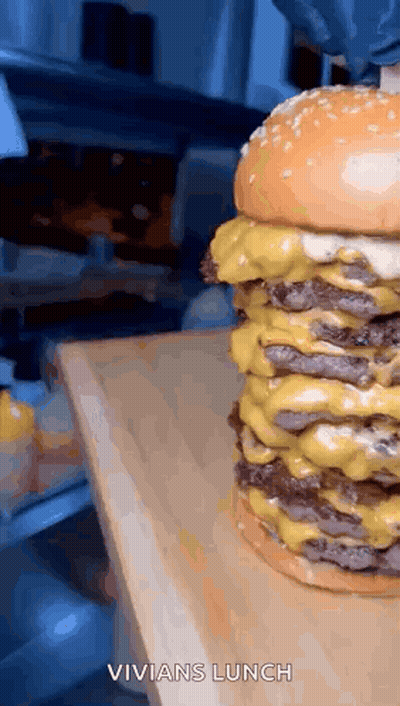 Triple Cheeseburger On Wooden Cutting Board GIF