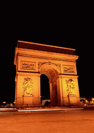 Triumphal Arch Lit Up At Night With Cars GIF