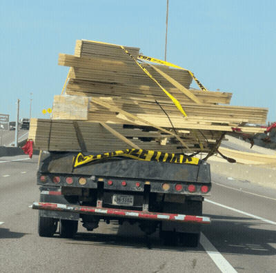 Truck Carrying Stack Of Wood With License Plate BC-510A GIF