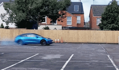 Truck Driving Down Street With Car Behind GIF