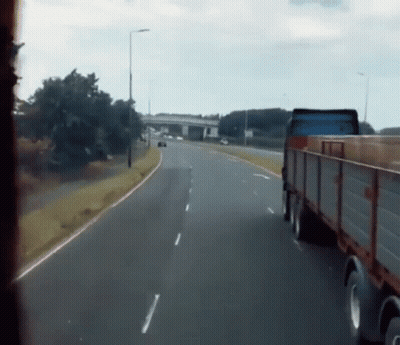 Truck Driving On Highway Next To Car GIF