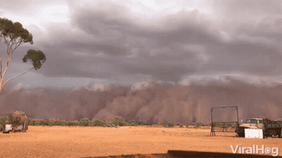 Truck Parked In Dirt Under Cloudy Sky GIF