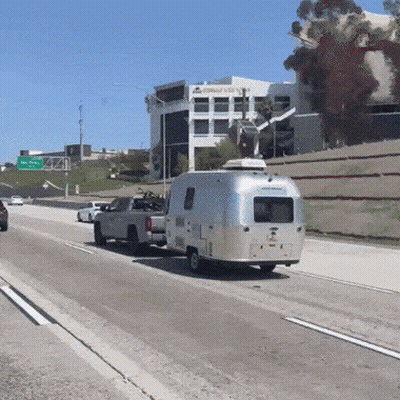 Truck Pulling Airstream Trailer On Freeway GIF