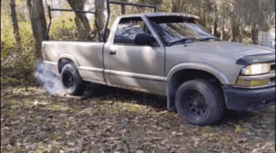 Truck With Smoking Tire In Woods GIF