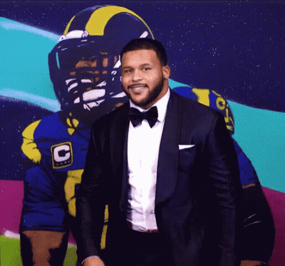 Tuxedo Man And Football Player With C Helmet GIF