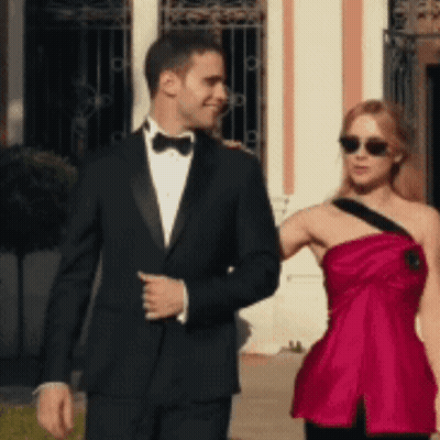 Tuxedo Man And Red Dress Woman Walking GIF