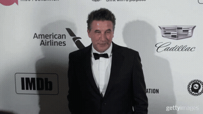 Tuxedo Man Facing Wall With American Airlines, Cadillac, IMDb GIF