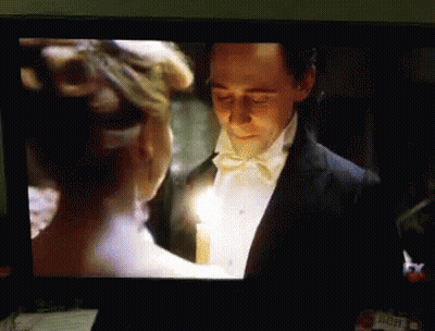 Tuxedo Man Holds Candle With White Dress Woman GIF