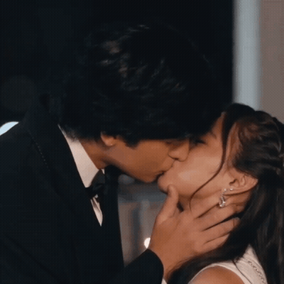 Tuxedo Man Kisses Woman On Cheek GIF