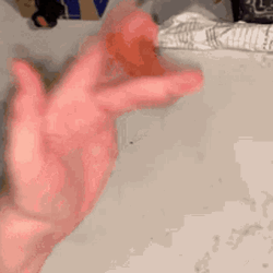 Twiddling Thumbs Flipping Hot Dog In Hands GIF