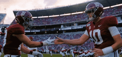 Two Alabama Football Players Shaking Hands GIF