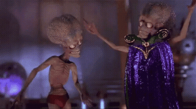 Two Aliens Standing Together GIF