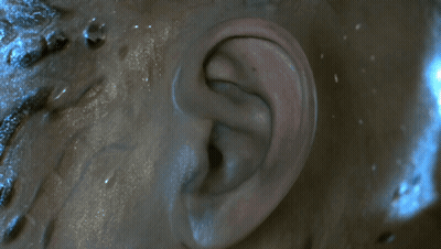 Two Aliens Standing Together One Holding Spear GIF