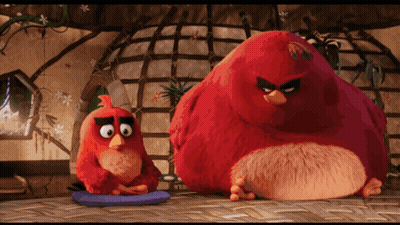 Two Angry Birds Sitting Next To Each Other On A Table GIF