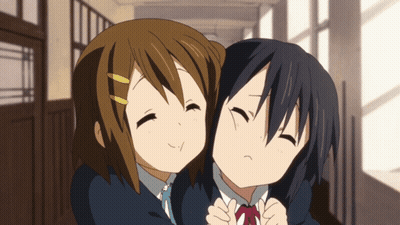 two anime girls hugging each other in a hallway with their eyes closed