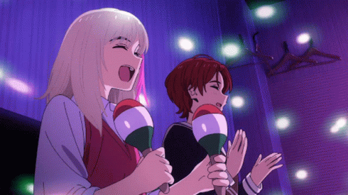 Two Anime Girls Singing Into Microphones While Holding Maracas In Their Hands GIF