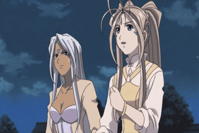 Two Anime Girls Standing Next To Each Other With One Having A Blue Circle On Her Forehead GIF