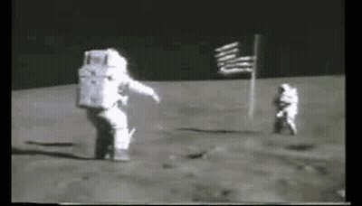 Two Astronauts Are Walking On The Moon . GIF