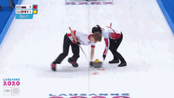 Two Athletes Sweeping Curling Stone GIF