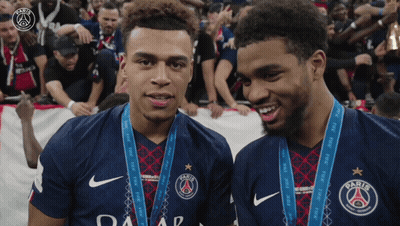 Two Athletes With Medals And Paris Jerseys GIF