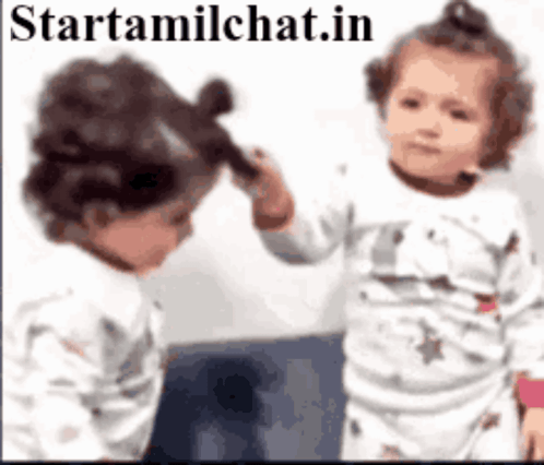 Two Babies Are Brushing Each Other 'S Hair In Front Of A Mirror With The Website Starttamilchat.in In The Corner GIF