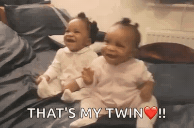 Two Baby Girls Sitting And Laughing GIF