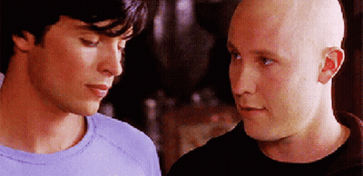 Two Bald Men Are Looking At Each Other In A Close Up GIF
