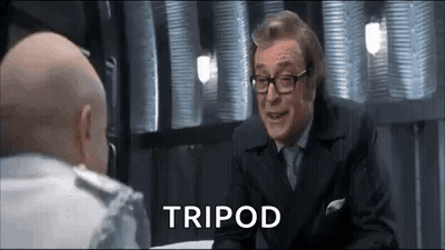 Two Bald Men In Suits Talking GIF