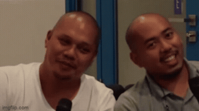 Two Bald Men Smiling Beside Microphone GIF