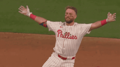 Two Baseball Players Are Hugging Each Other And One Of Them Has The Number 12 On His Jersey GIF