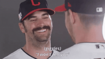 Two Baseball Players Are Laughing And One Of Them Is Wearing A Hat With The Letter L On It GIF