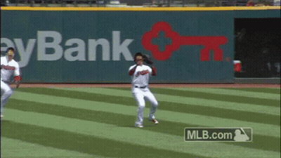 Two Baseball Players Are Running On A Field With A Mlb.com Advertisement Behind Them GIF