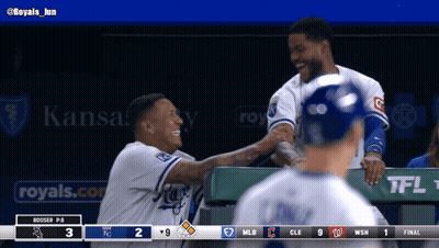 Two Baseball Players Are Shaking Hands In A Dugout With A Kansas City Ad Behind Them GIF