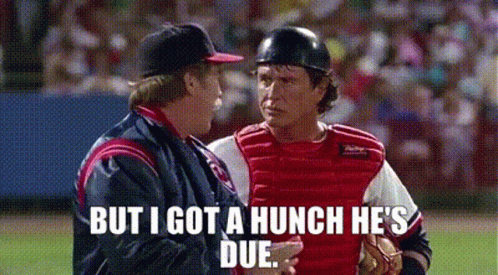 Two Baseball Players Are Talking To Each Other On A Baseball Field . GIF