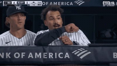 Two Baseball Players Behind A Bank Of America Banner During A Game GIF