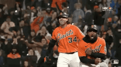 Two Baseball Players Celebrating In Orange Giants Jerseys GIF