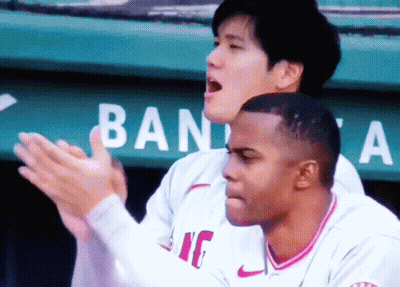 Two Baseball Players Clapping In Front Of Ban Sign GIF