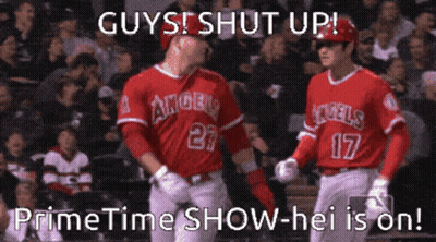 Two Baseball Players From The Angels Are Standing On The Field GIF