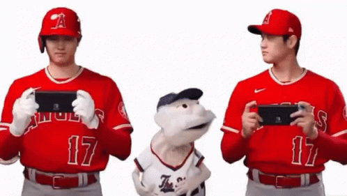 Two Baseball Players Holding Nintendo Switch Next To Stuffed Animal GIF