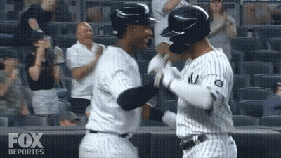 Two Baseball Players Hugging Fox Deportes Logo GIF