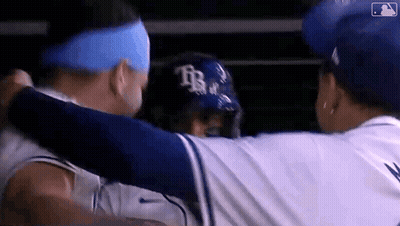 Two Baseball Players Hugging In Dugout GIF