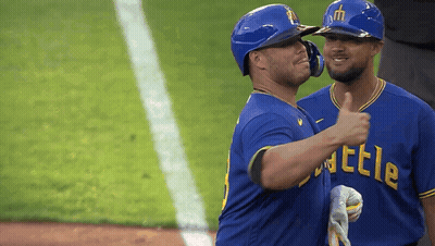 Two Baseball Players In Blue Shirts Saying Battle GIF
