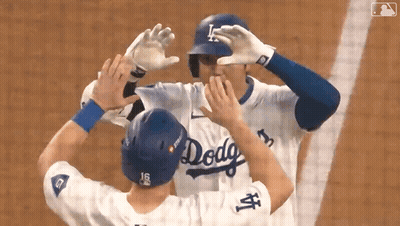 Two Baseball Players In Dodgers Uniforms Hugging GIF
