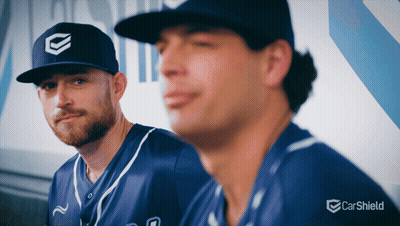 Two Baseball Players In Dugout With Carsheld Logo GIF