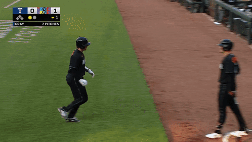Two Baseball Players On A Field With A Scoreboard That Says A. Rutschmann GIF