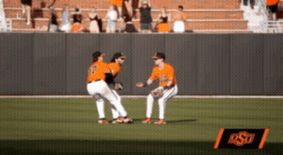 Two Baseball Players On A Field With A Sign That Says Ost In The Background GIF