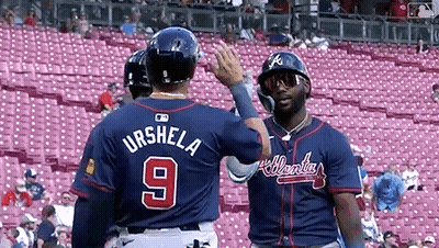 Two Baseball Players Standing Next To Each Other GIF