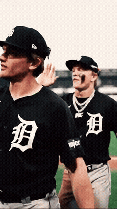 Two Baseball Players Wearing Black Uniforms With The Letter D On The Front GIF
