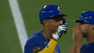 Two Baseball Players Wearing Blue And Yellow Uniforms With The Number 4 On The Sleeve GIF