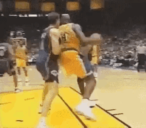 Two Basketball Players Are Fighting Each Other On A Court . GIF